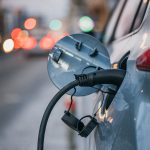 Close-up of an electric car plugged in and charging at the roadside