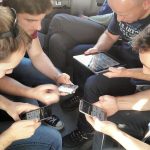 A group of friends playing a multiplayer mobile game together
