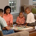 Family playing a board game together at home