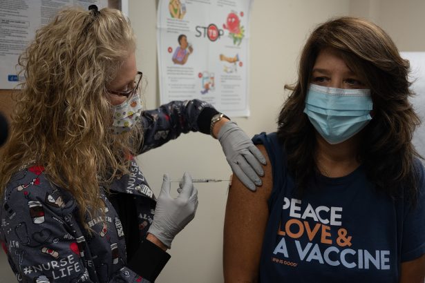 Healthcare worker preparing a measles vaccine dose at a clinic